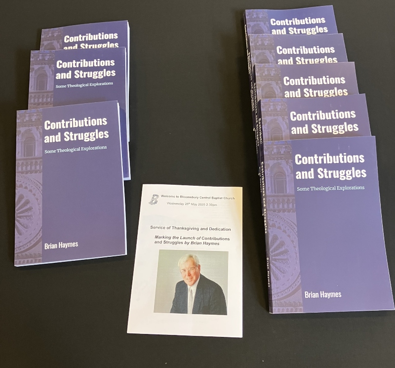 Several copies of the book Contributions and Struggles by Brian Haymes laid on a table, with a copy of the dedication service sheet