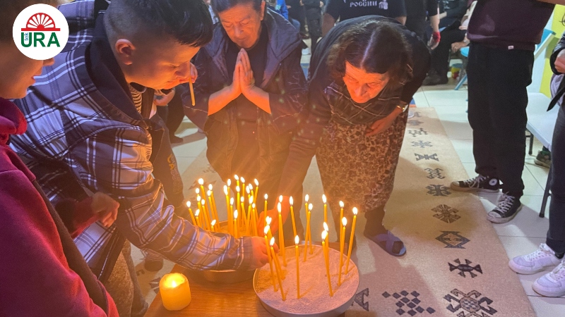 People in Albania served the by charity Tek Ura lights candles