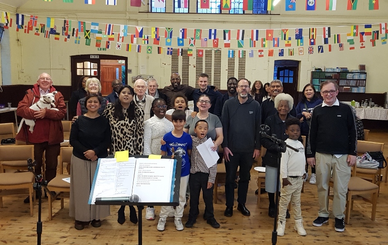 Hub at Cricklewood - a group of people in a church building smile for the camera