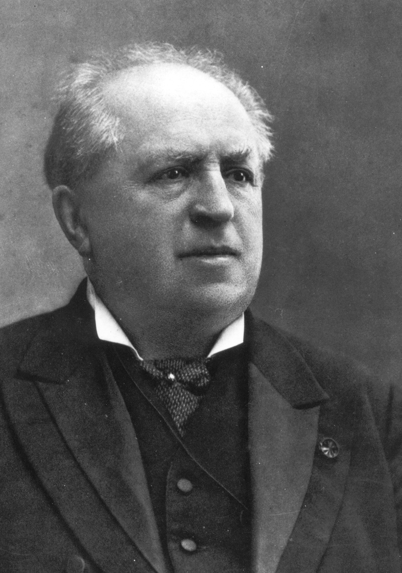 Black and white image of Abraham Kuyper wearing a suit, looking away from the camera
